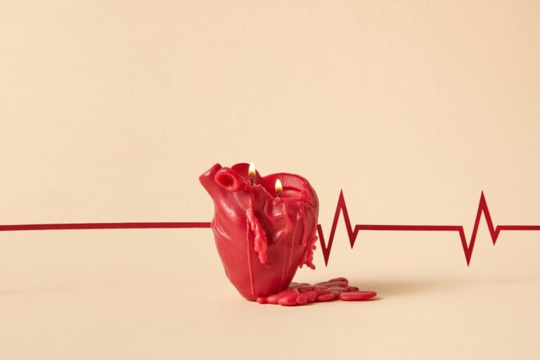 Creative heart-shaped candle melting with lit flames, against a backdrop of an ECG line symbolizing heartbeat.